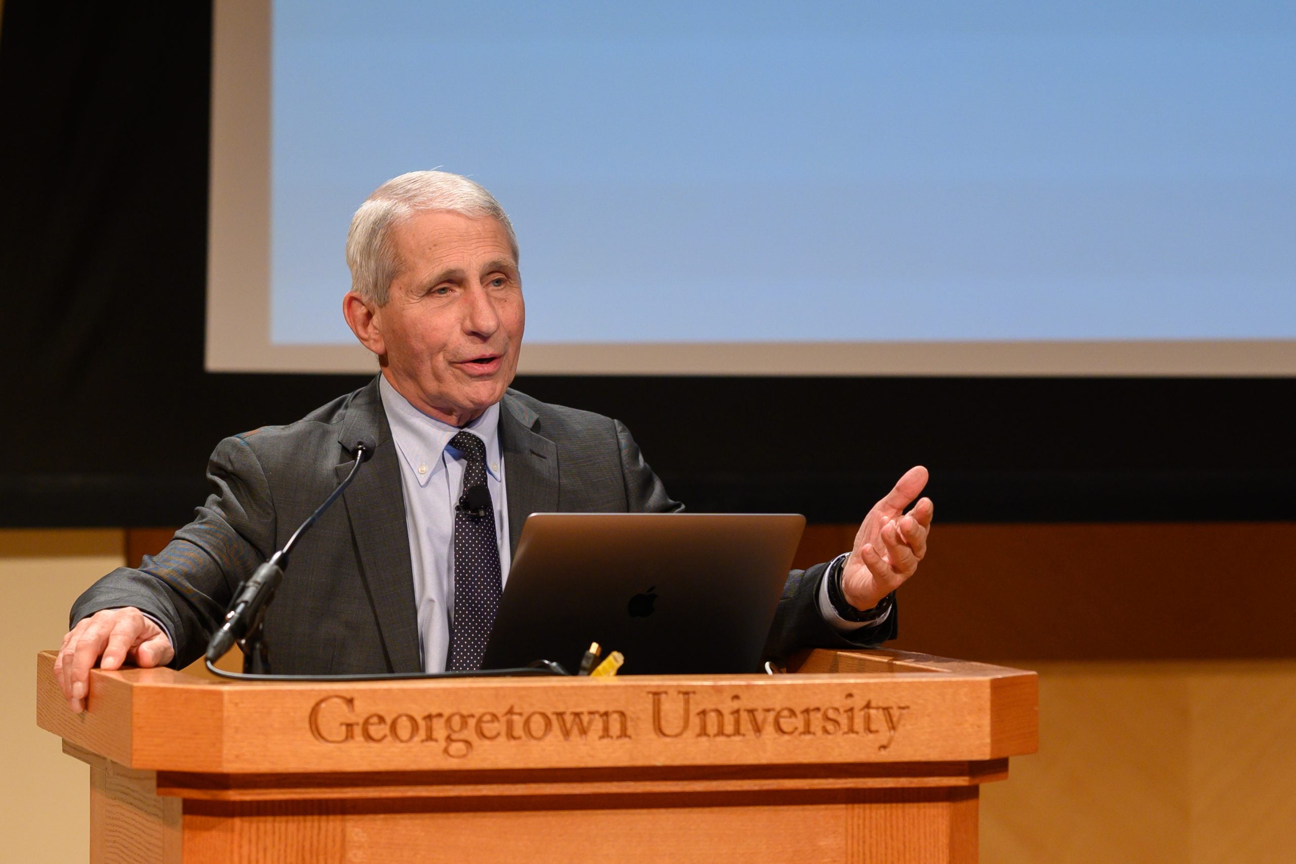 Dr. Anthony Fauci delivers a presentation at a podium in the Lohrfink Auditorium