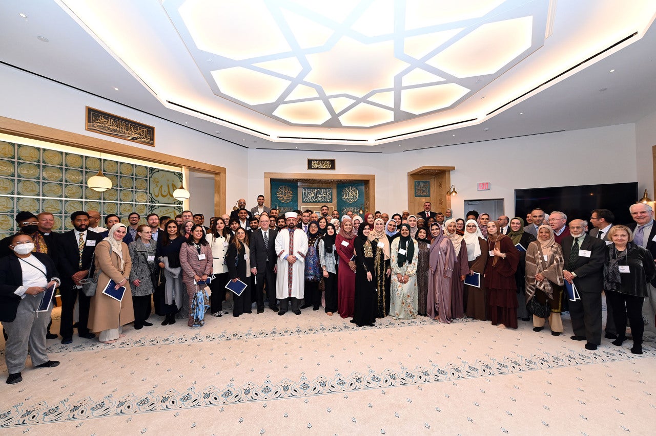 Students, alumni, Georgetown community members, Muslim leaders, a representative of the DC Council and diplomats from Turkey, Qatar and Indonesia pose for a photo at the March 18 event.