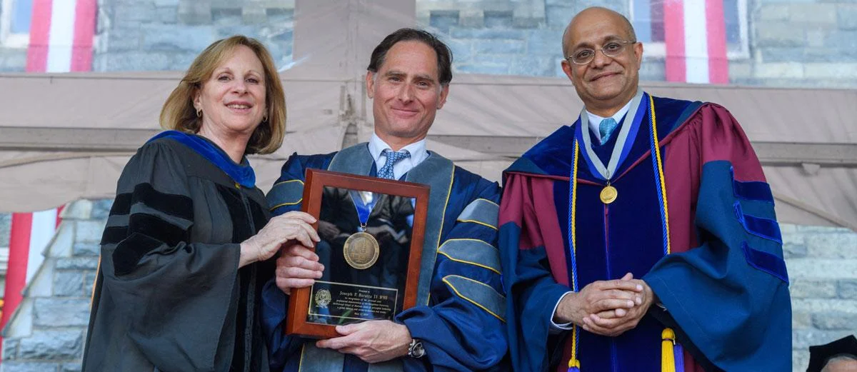 Joe Baratta, at center, at the 2019 McDonough School of Business commencement ceremony. He is holding the Dean's Medal he was awarded that day.