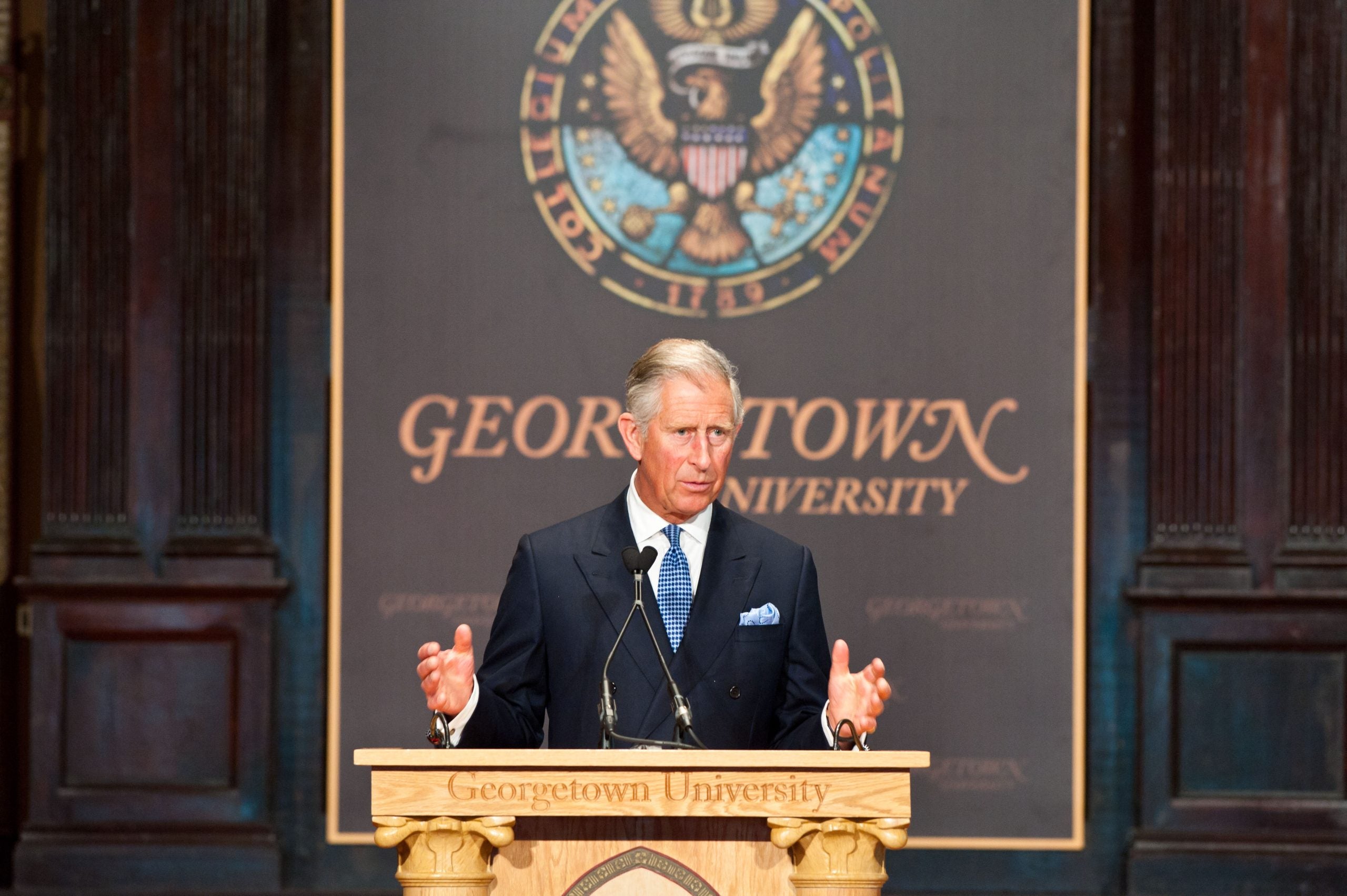 King Charles stands at a podium to deliver remarks at an event in Gaston Hall.