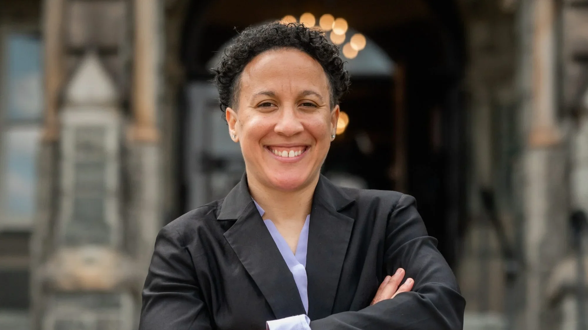 Danielle Deshaies (SSP'23) smiles in front of Healy Hall.