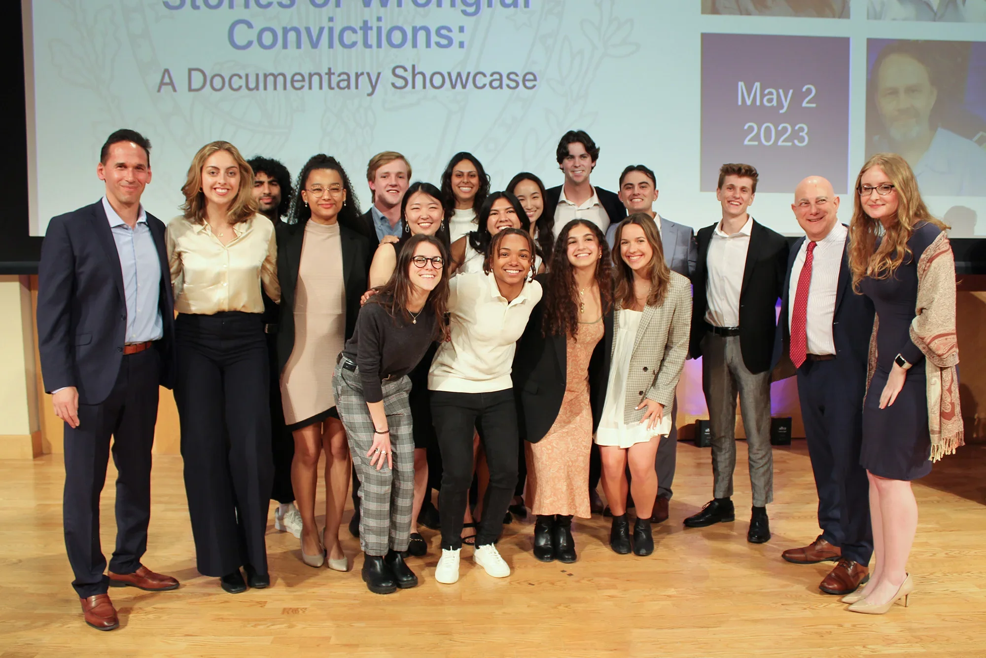 Students in the Making An Exoneree program pose on stage.