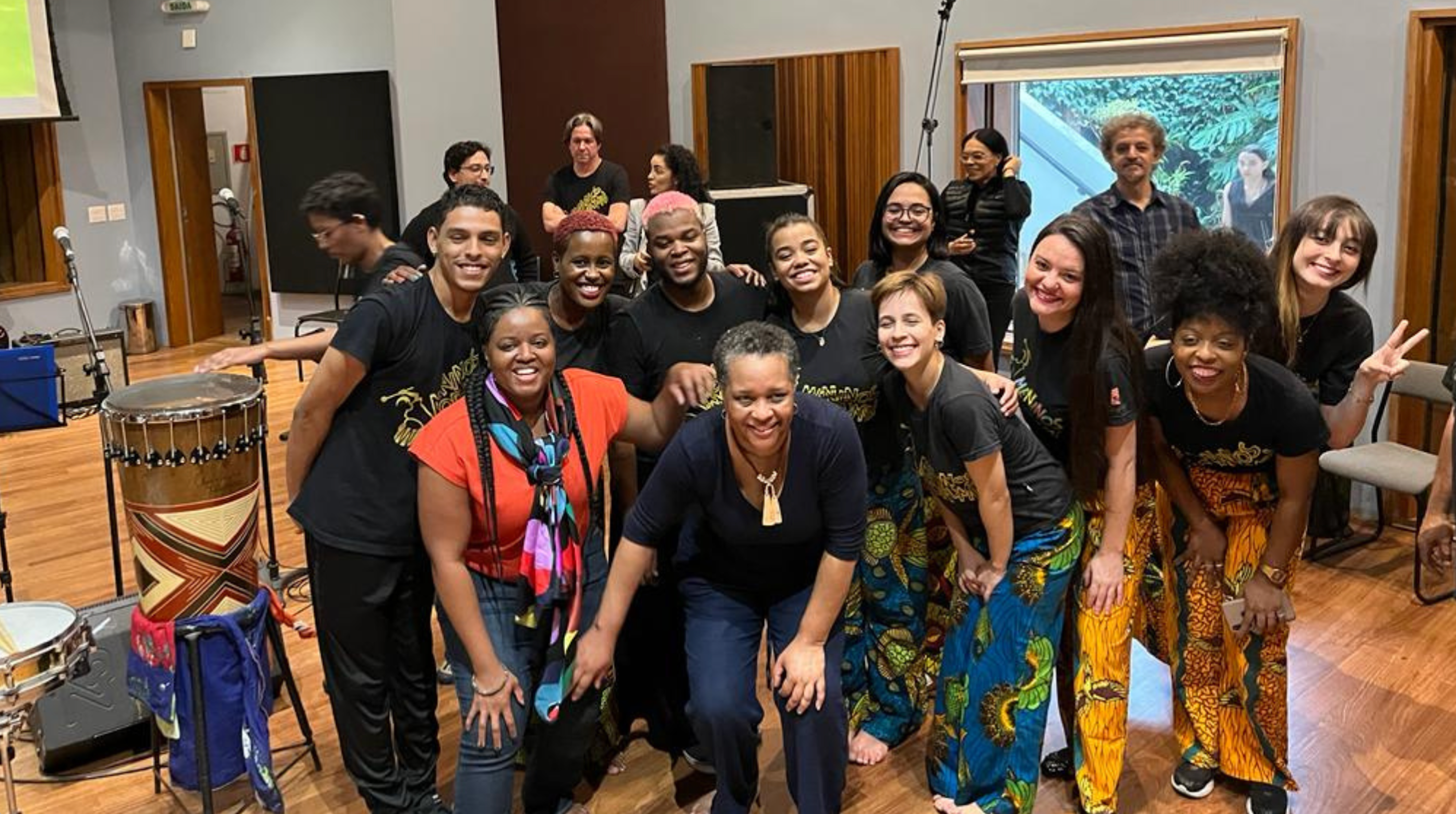 A group of people in a room with a percussion instrument. Carline Noailles (EMBA'23) is at the center of the photo.