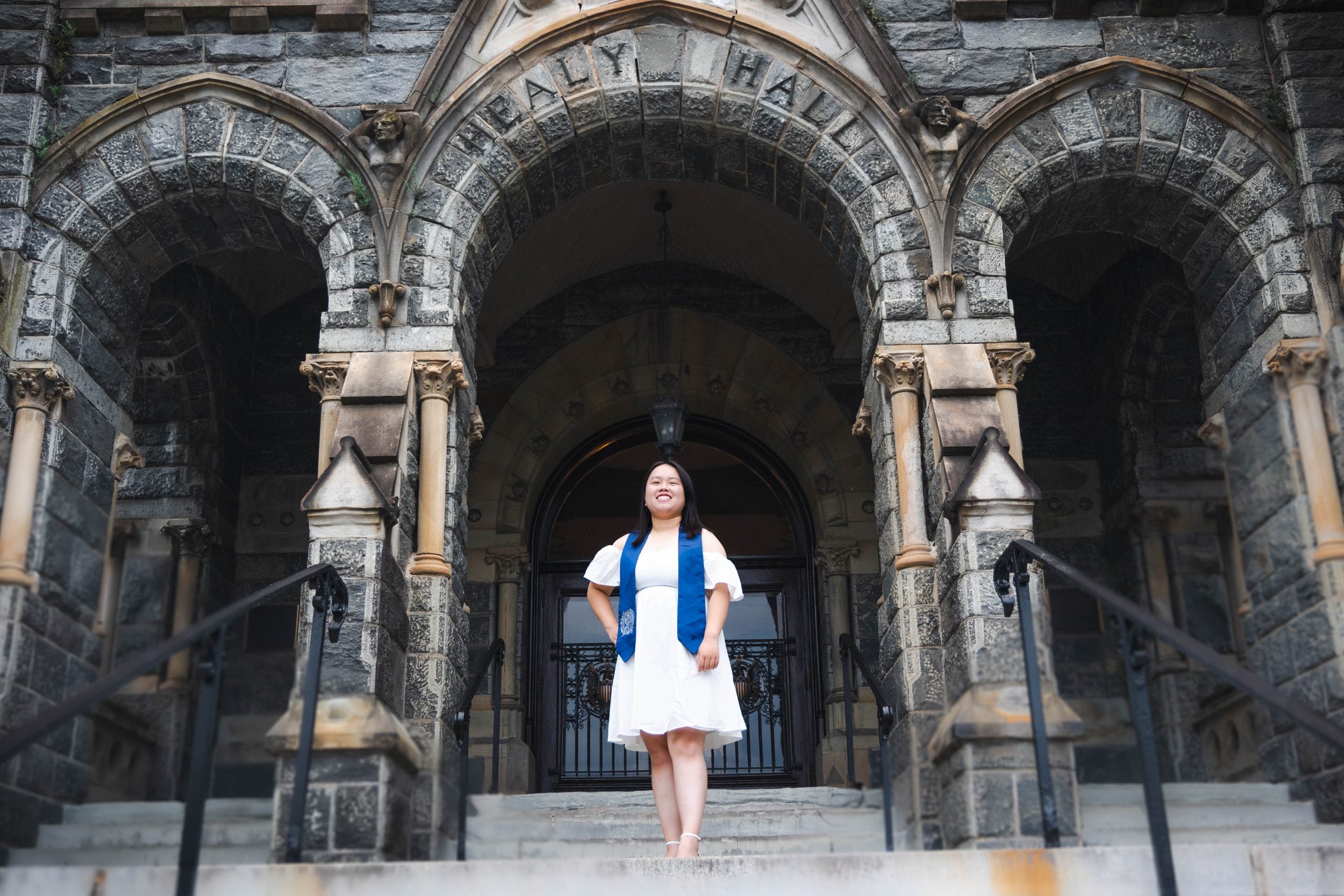 Sofia Chen Ma (B'23) stands on the Healy steps outside Healy Hall in the weeks before her graduation from Georgetown.