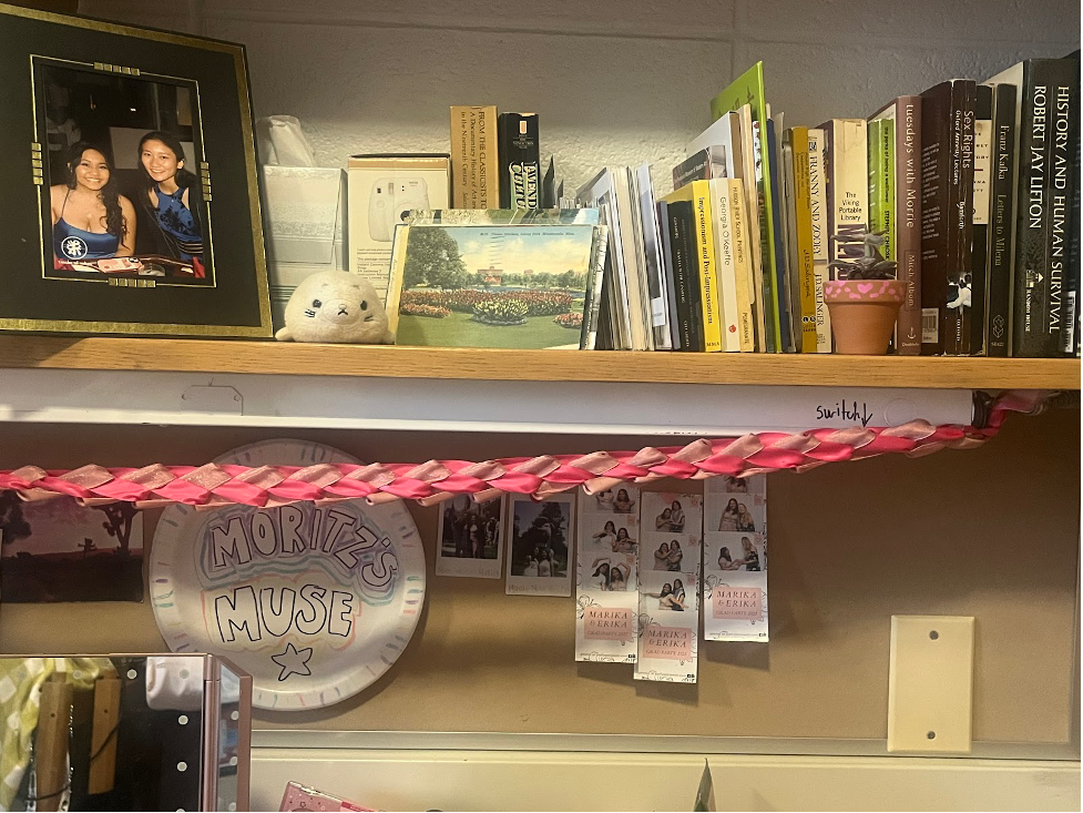 A close-up of a dorm desk topped with decor and pictures