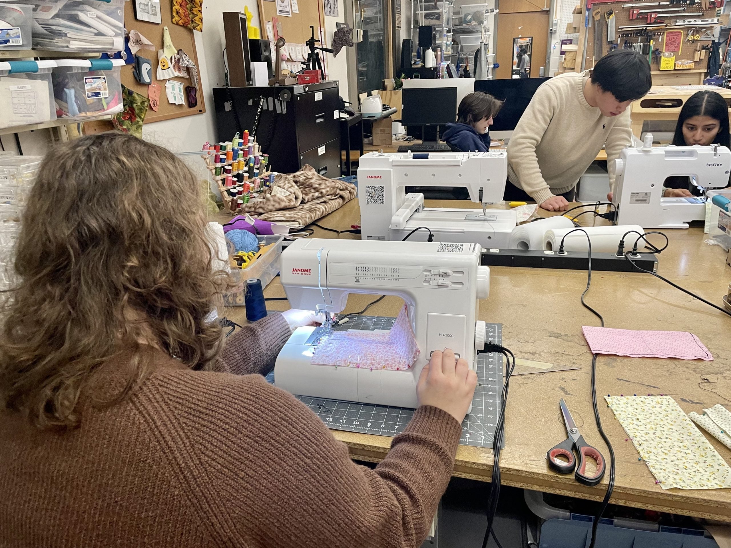 Students diligently sewing at the Makerhub