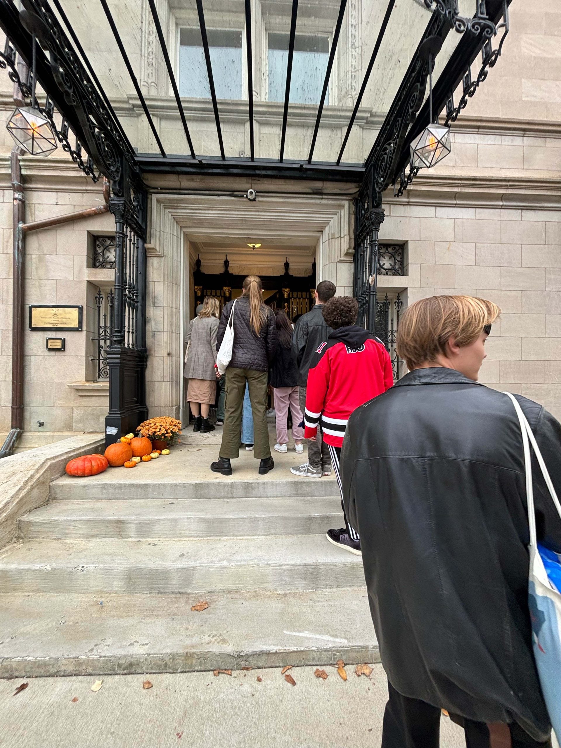 People line up outside an embassy for Halloween to Trick or Treat