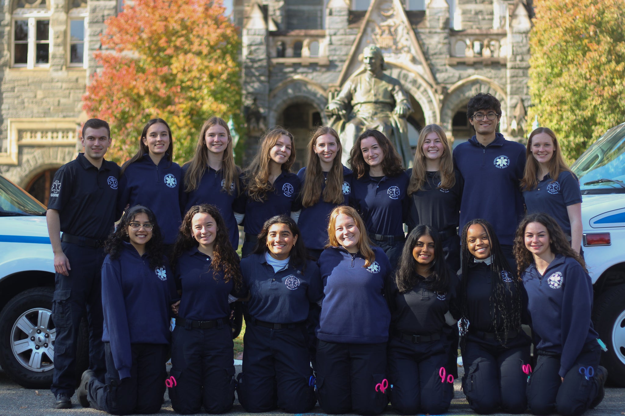 The volunteers for the student-run ambulance service, GERMS, pose together in front of Healy Hall in the fall.