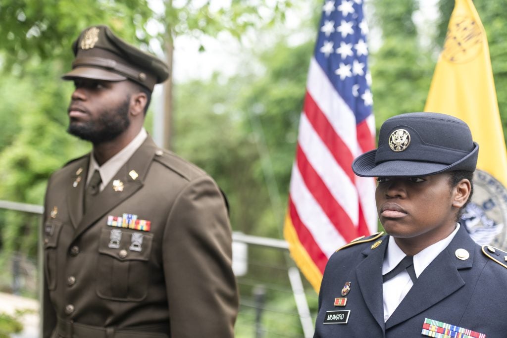 Lester and Amani Mungro standing at attention in their Army uniforms