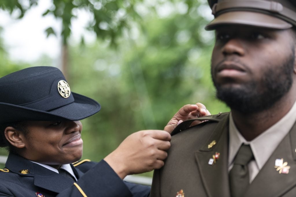 Amani Mungro pinning Lester Mungro, both in Army dress uniforms