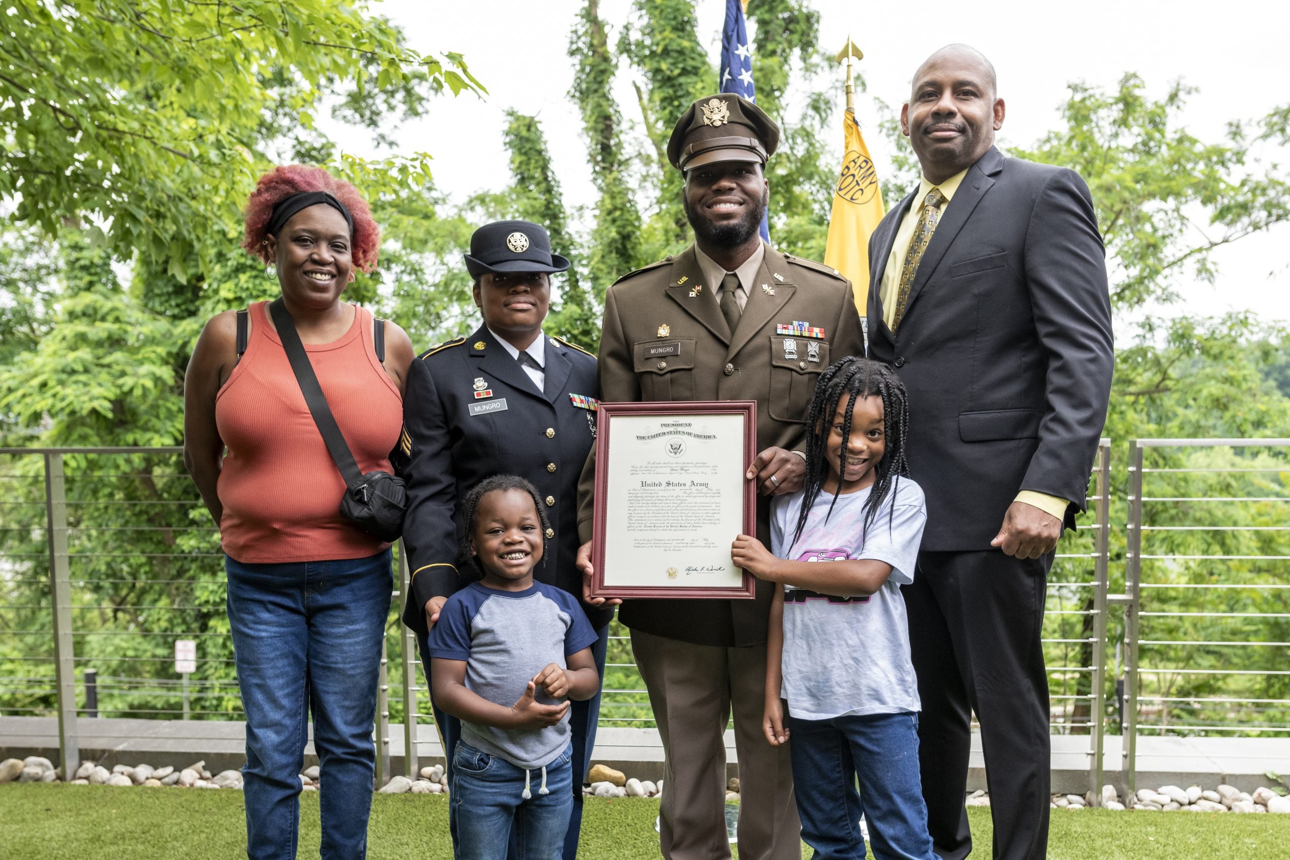 Lester Mungro in his military dress uniform with his father, mother, wife, and two kids