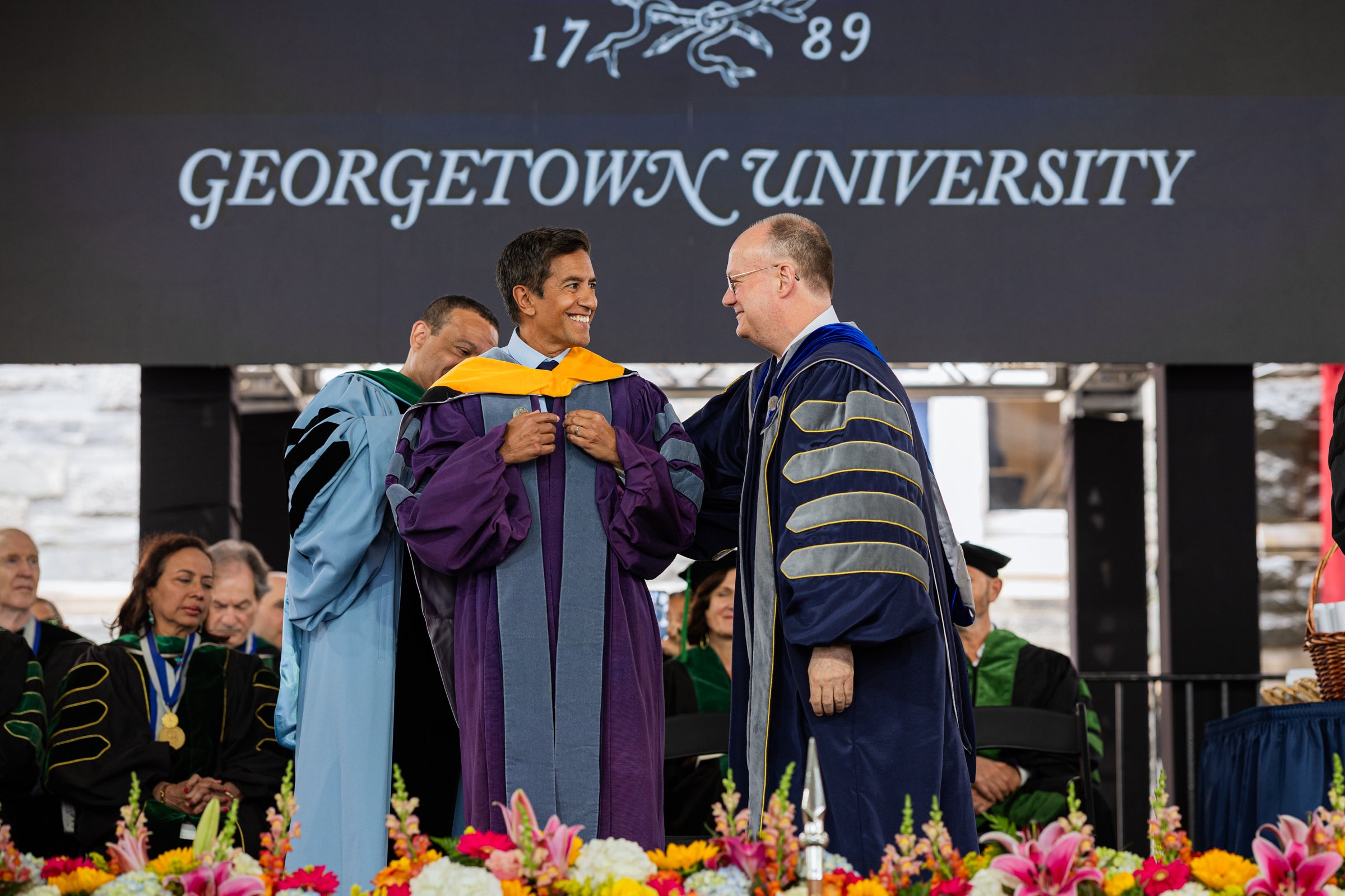 Sanjay Gupta getting his honoroary degree from PResident DiGioia and the dean.
