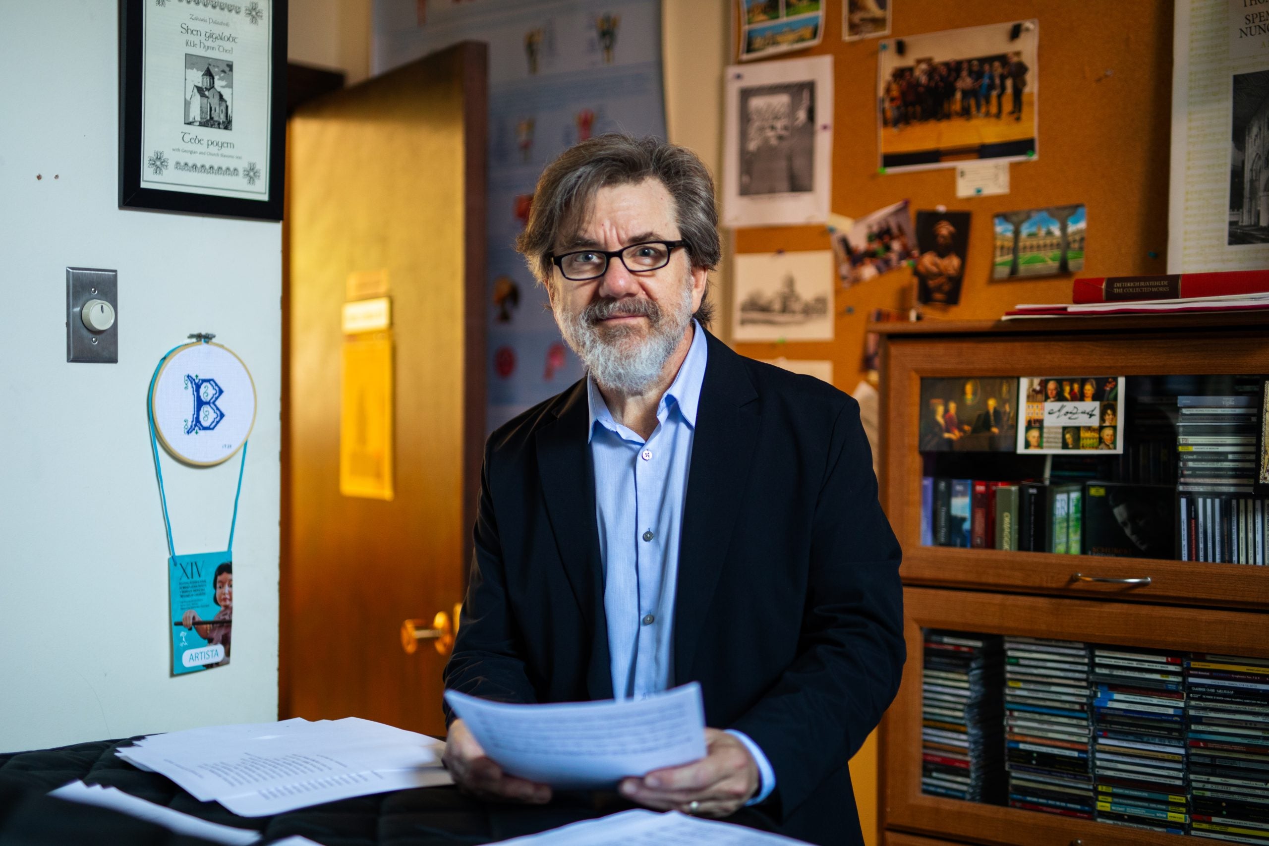 Fred Binkholder in his office holding a paper