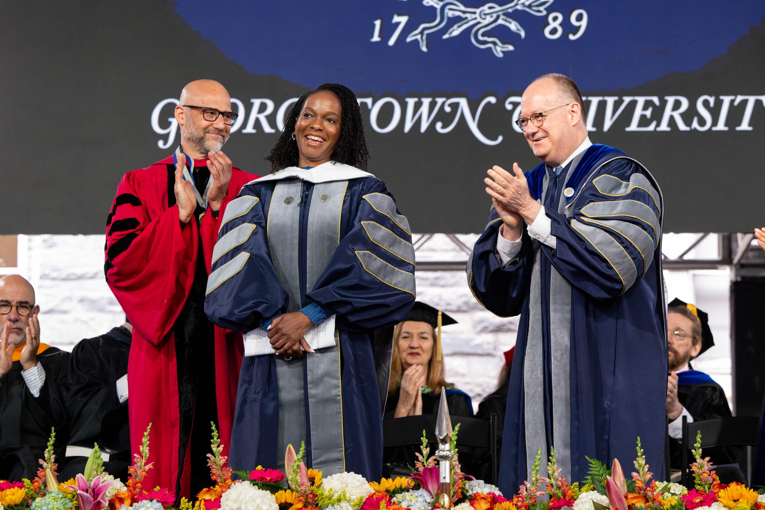 Imani Perry getting her honorary degree on stage with President DiGioia