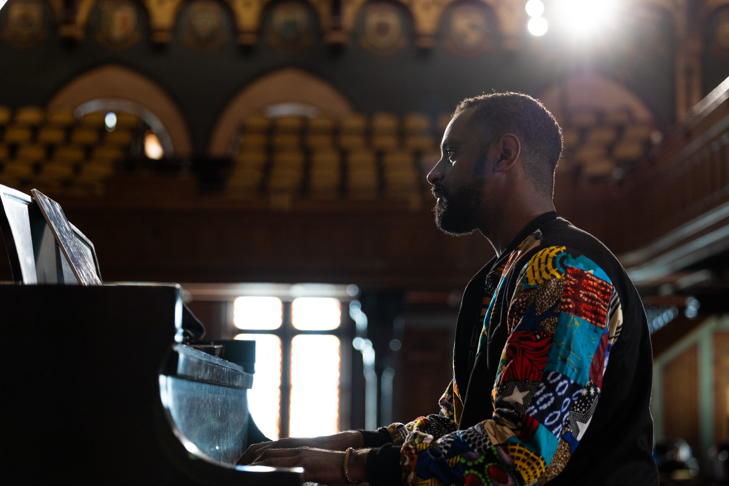 Carlos Simon playing a piano in Gaston Hall