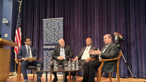 A panel on a stage discussing space policy
