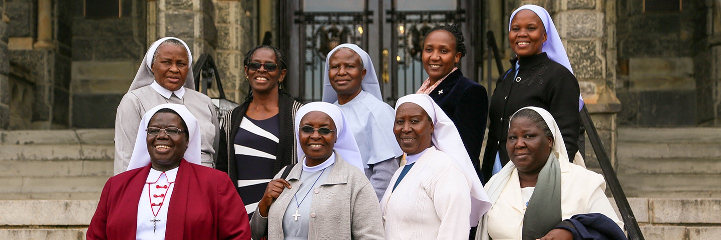 A group of African Catholic sisters on the steps of Healy Hall