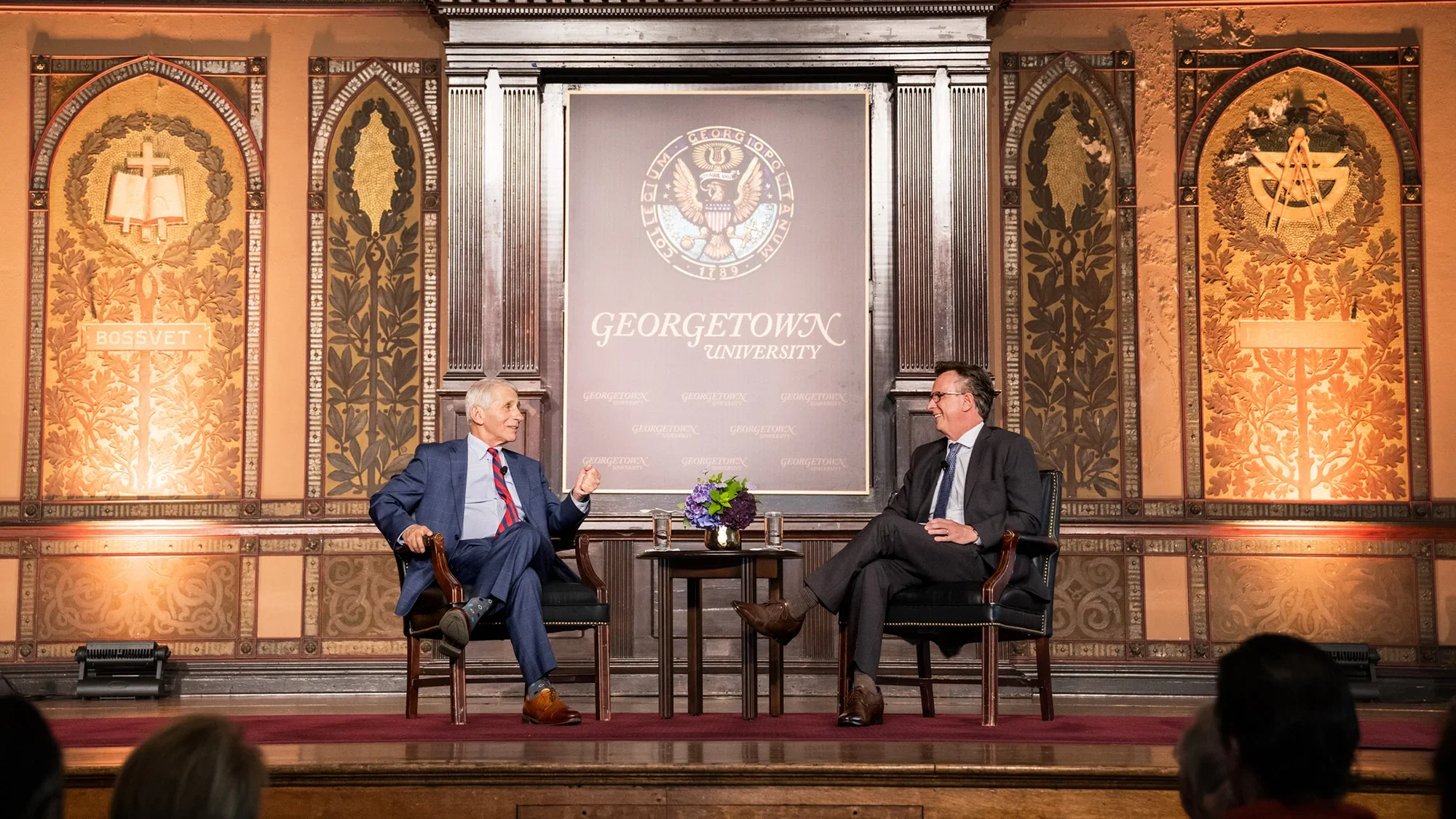 Fauci and Beauchamp in chairs and talking in Gaston Hall