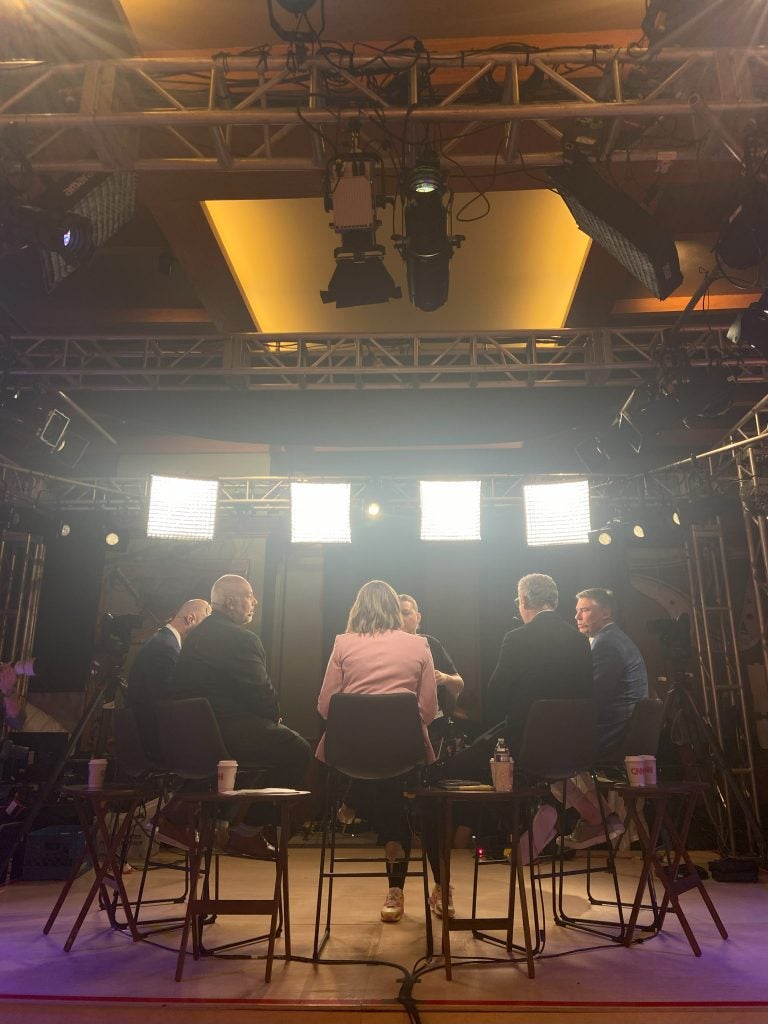 A group of panelists on set for a political news show