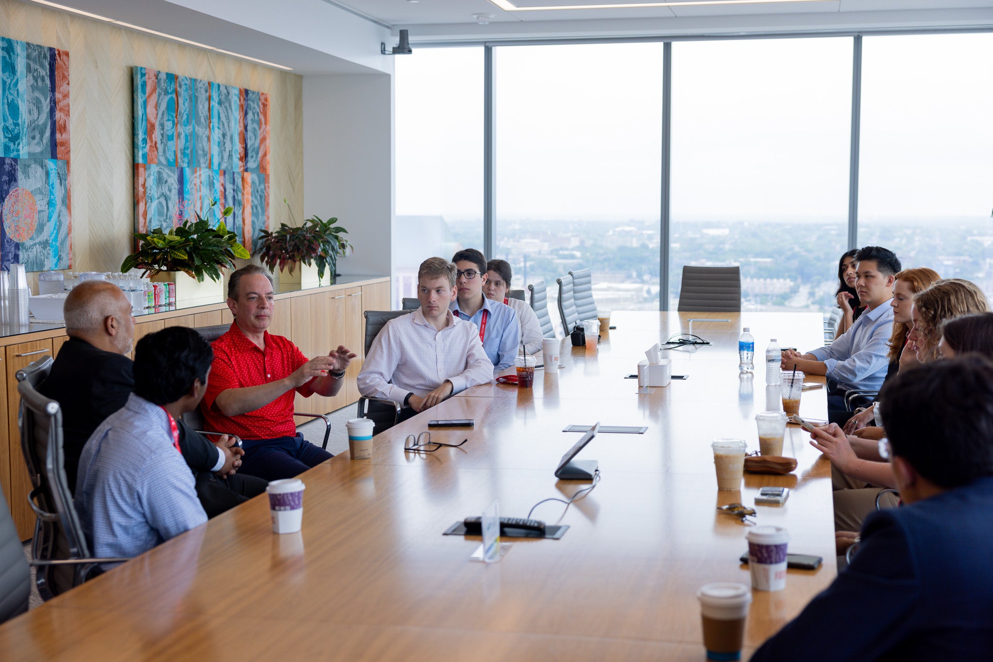 Students at a long table meeting with Reince Priebus