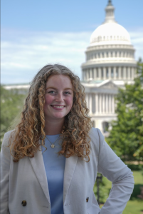 Maddie Davis in professional attire with the US Capitol in the background