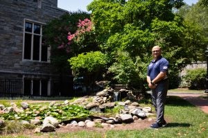 Haroot standing by the koi pond by White Gravenor Hall