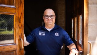 Haroot in a Georgetown polo standing in a doorway