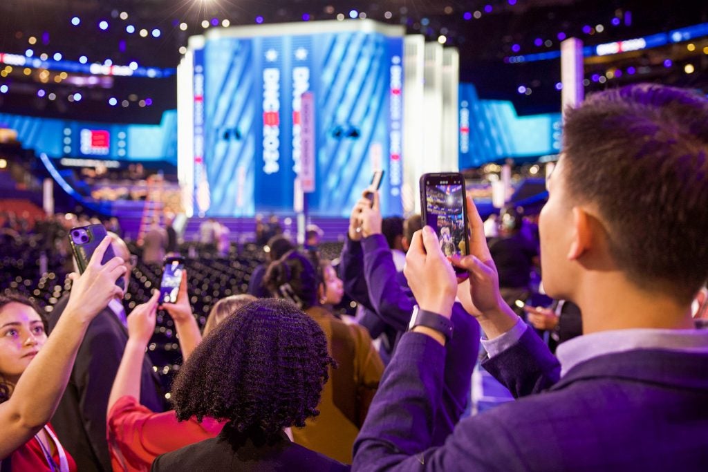 Bennie Chang taking a photo on the convention center of the DNC