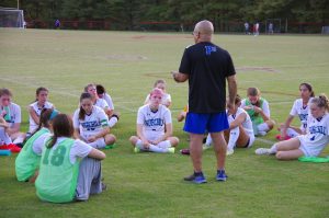 Haroot coaching a group of young girls.