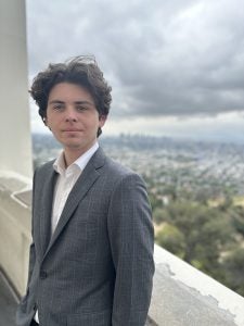 Matlock in a suit overlooking the city