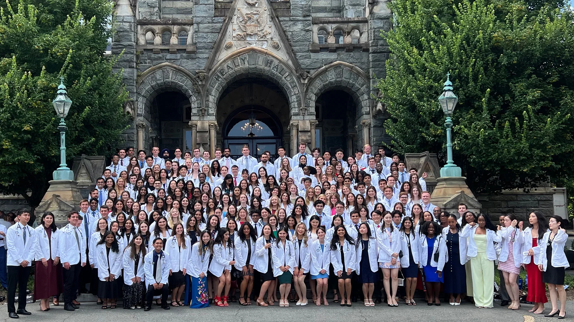 Hundreds of new medical students gather in white coats to celebrate the start of medical school.