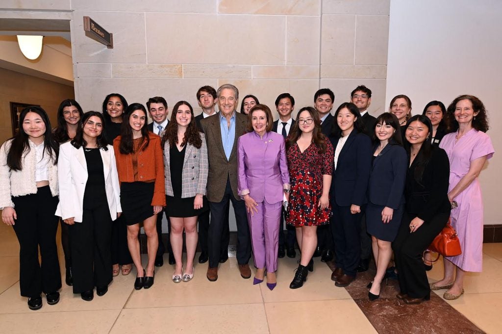 Students standing with Nancy Pelosi