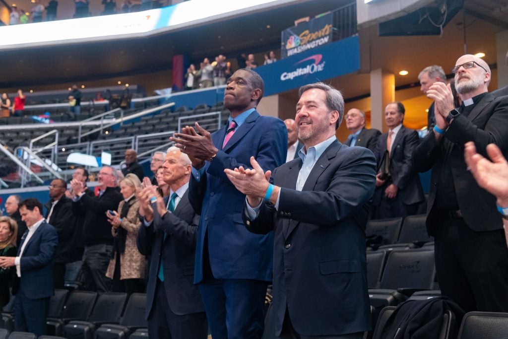 Dikembe Mutombo in a suit and tie at the Capital One Arena