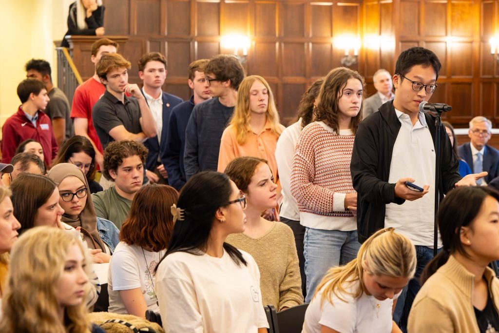 A line of students in Copley Formal Lounge waiting to ask questions of the governors.