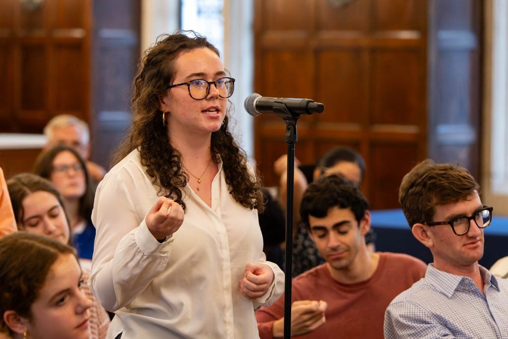 A young woman at a mic asking a question