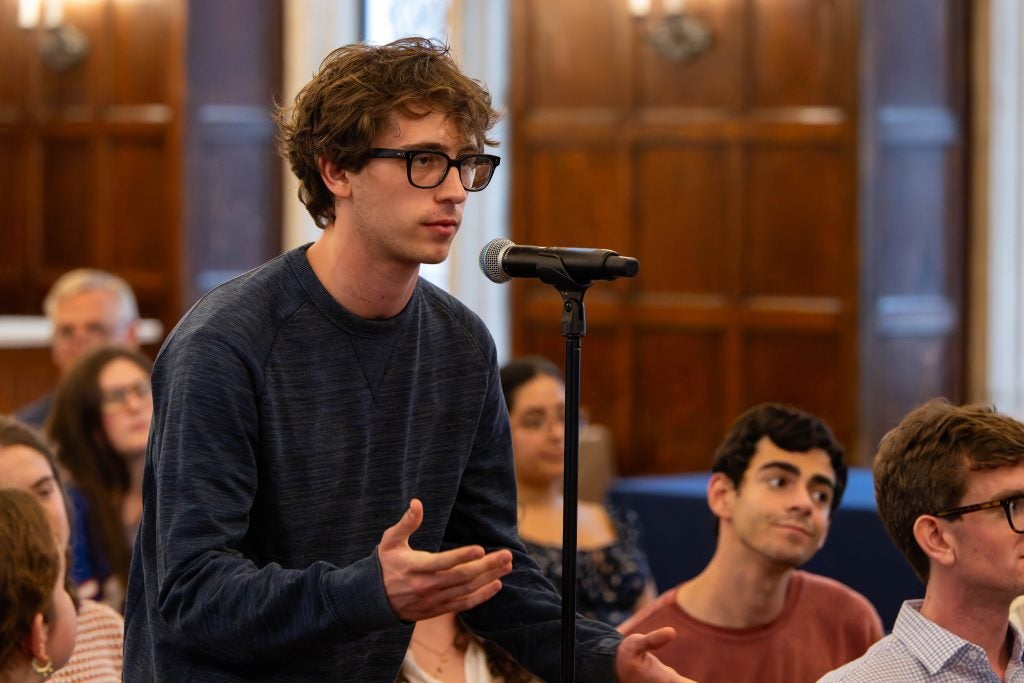 A young man at a mic asking a question