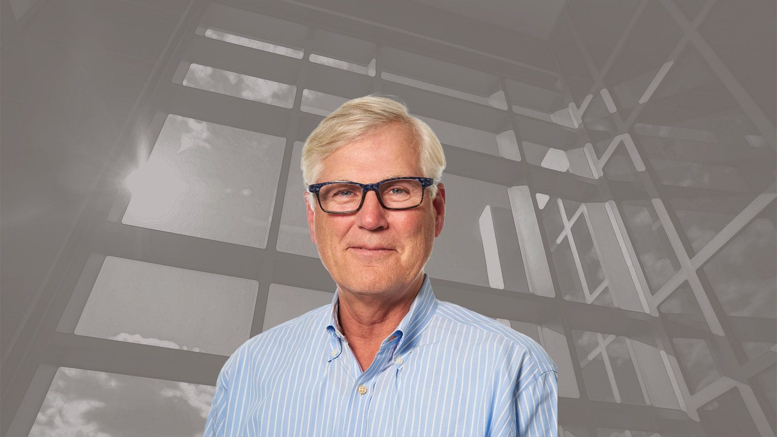 David Scadden headshot against an image of the Lombardi atrium windows