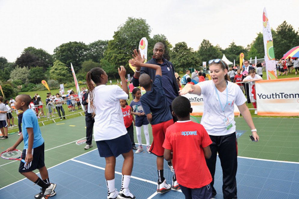 Mutombo high fiving children