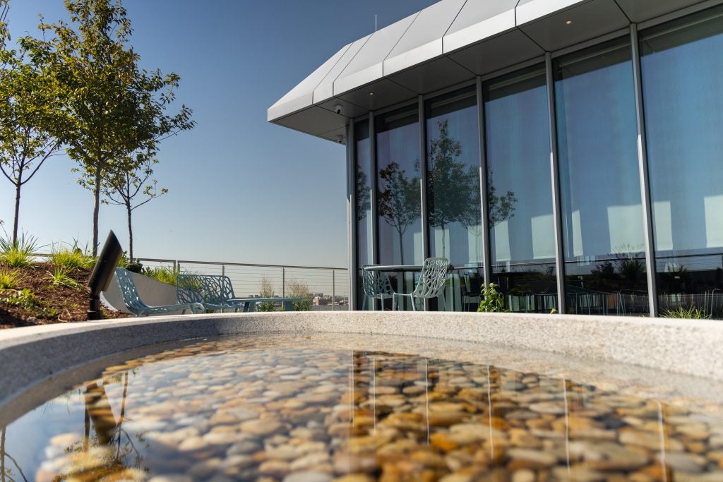 An art installation with a basin of rocks and water.