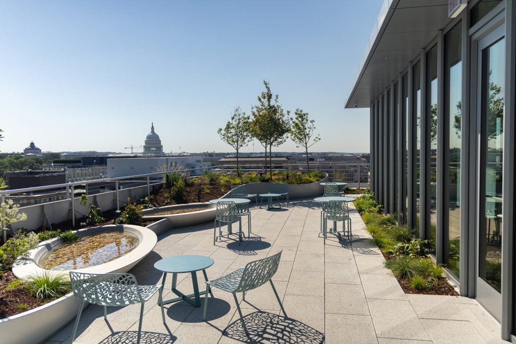 A rooftop patio with a view of the U.S. Capitol.