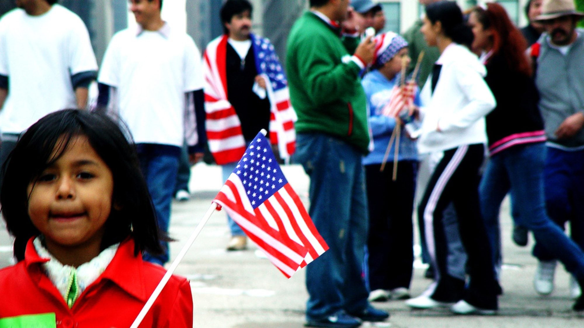 A young girl holds an American flag during a stand for immigrants&#039; rights in Chicago, May 1, 2006