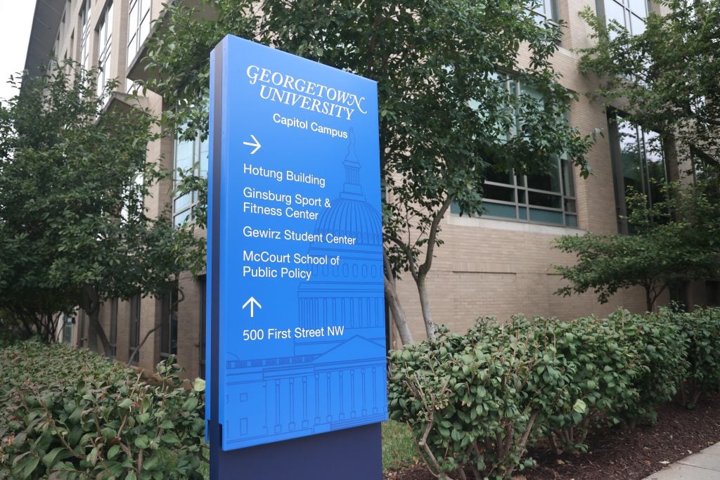 A blue sign with signs for Georgetown's Capitol Campus.