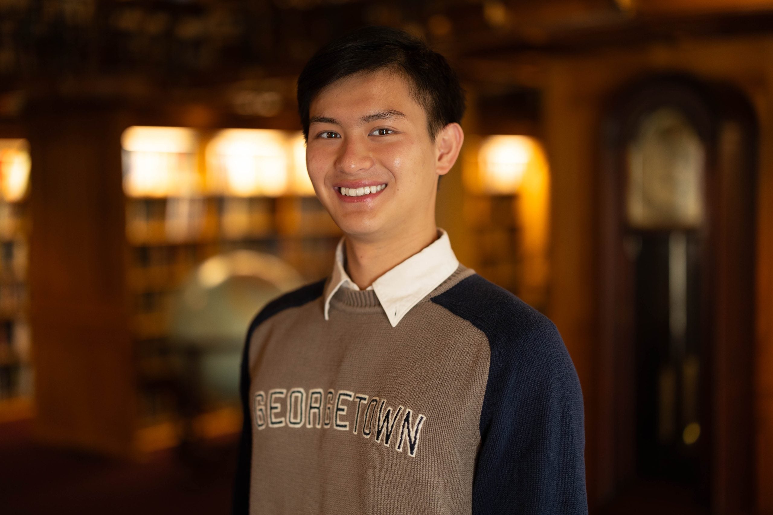 Bennie Chang in a Georgetown sweatshirt in a dark room