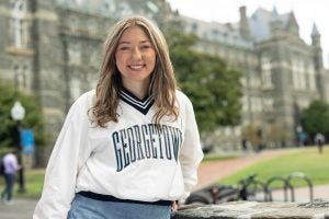 Ninabella Arlis in a white GU sweatshirt in Healy Lawn