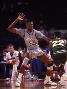 Dikembe Motombo in a Georgetown basketball uniform plays in a game