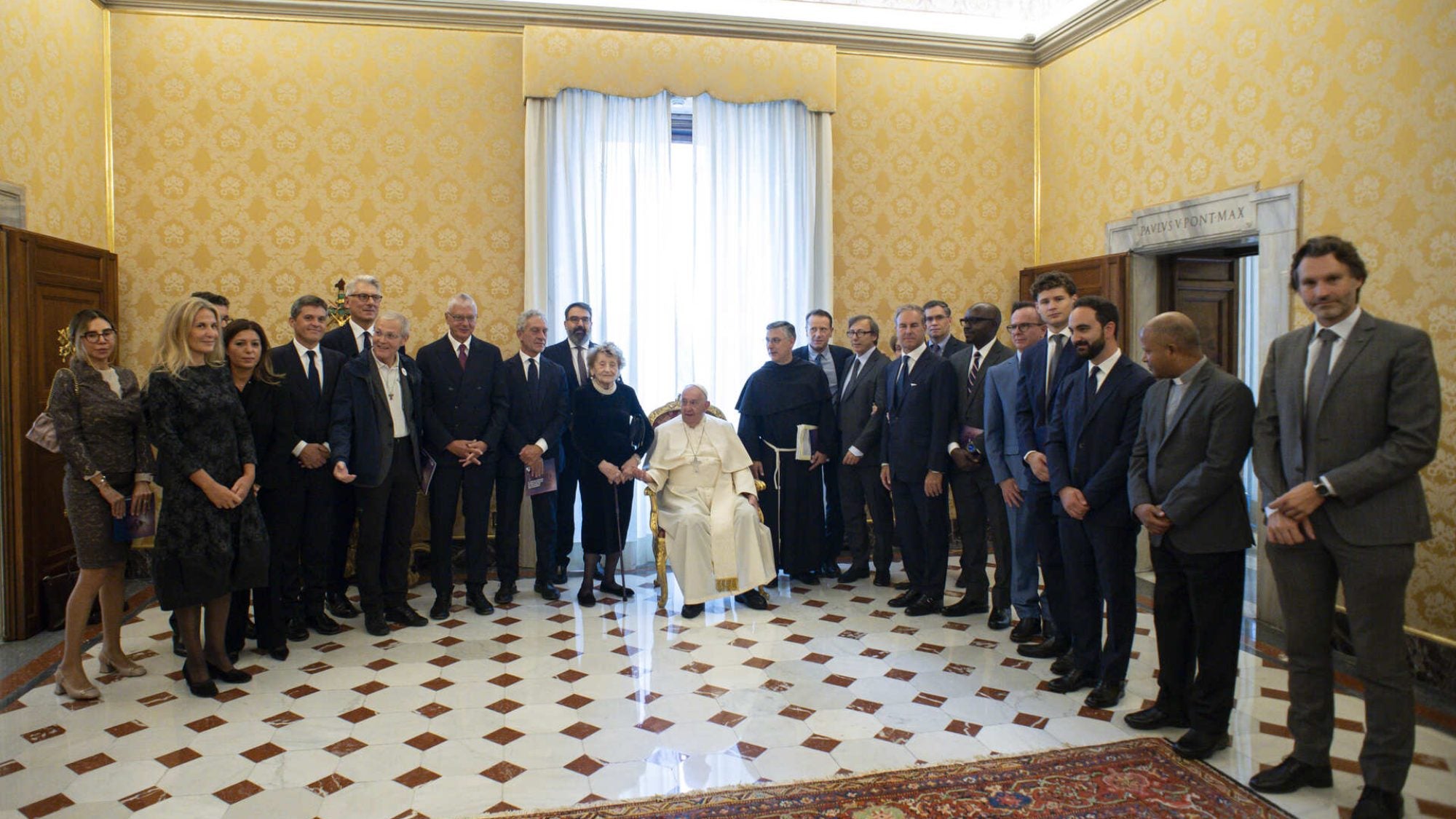 Pope Francis stands with a group of leaders in a room at the Vatican.