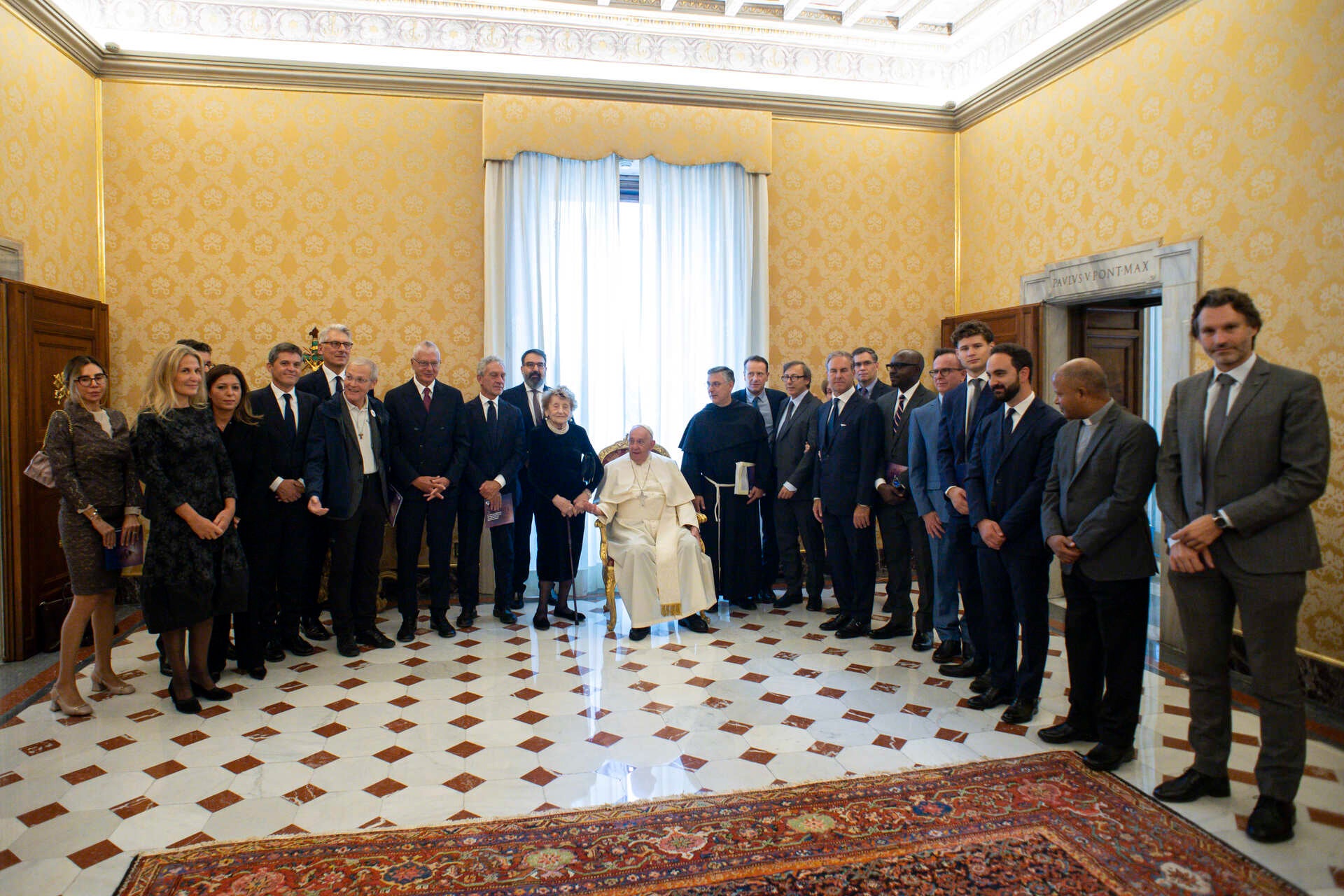 Pope Francis stands with a group of leaders in a room at the Vatican.