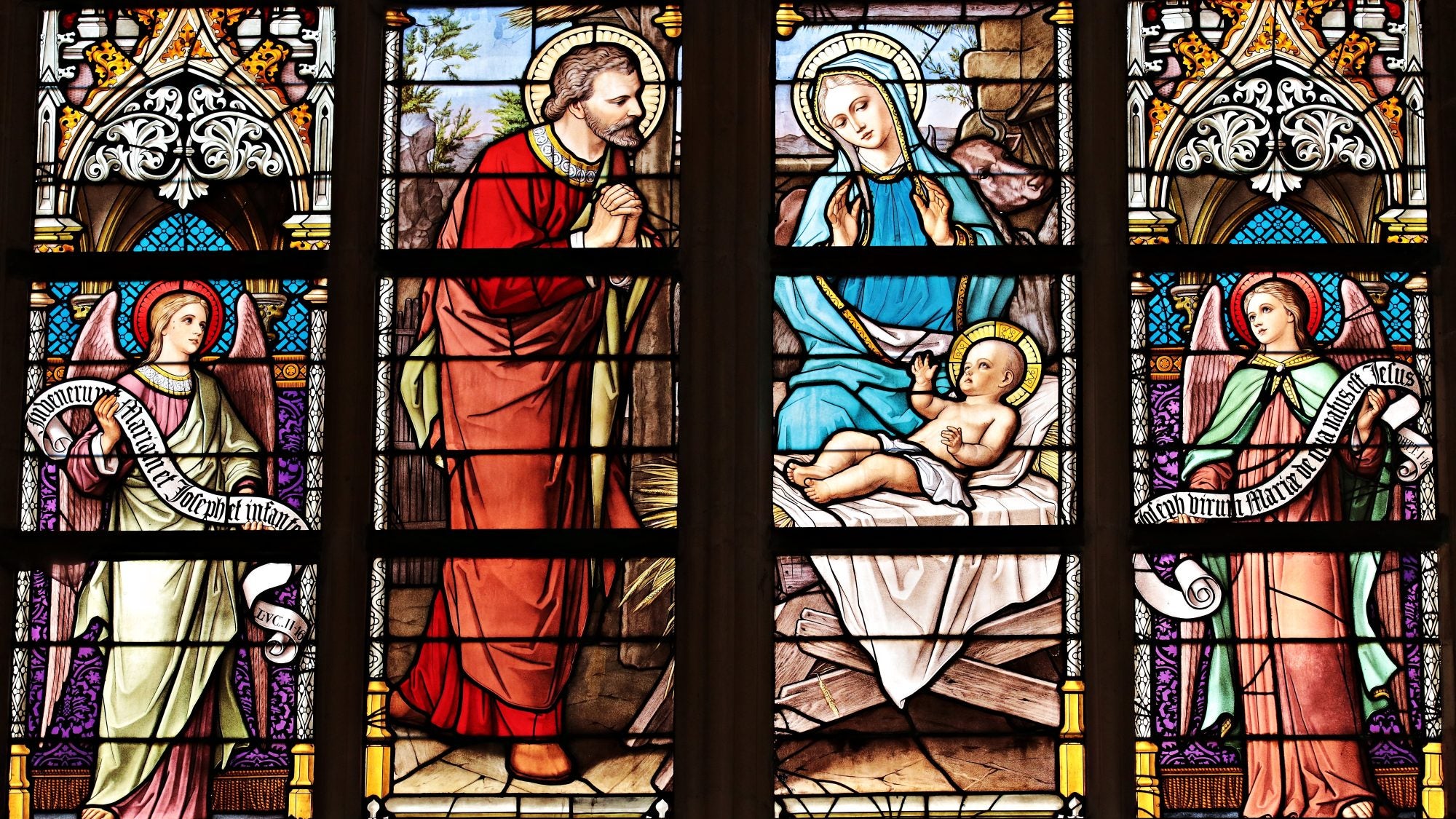 Stained glass window depicting baby Jesus, Mary, and Joseph