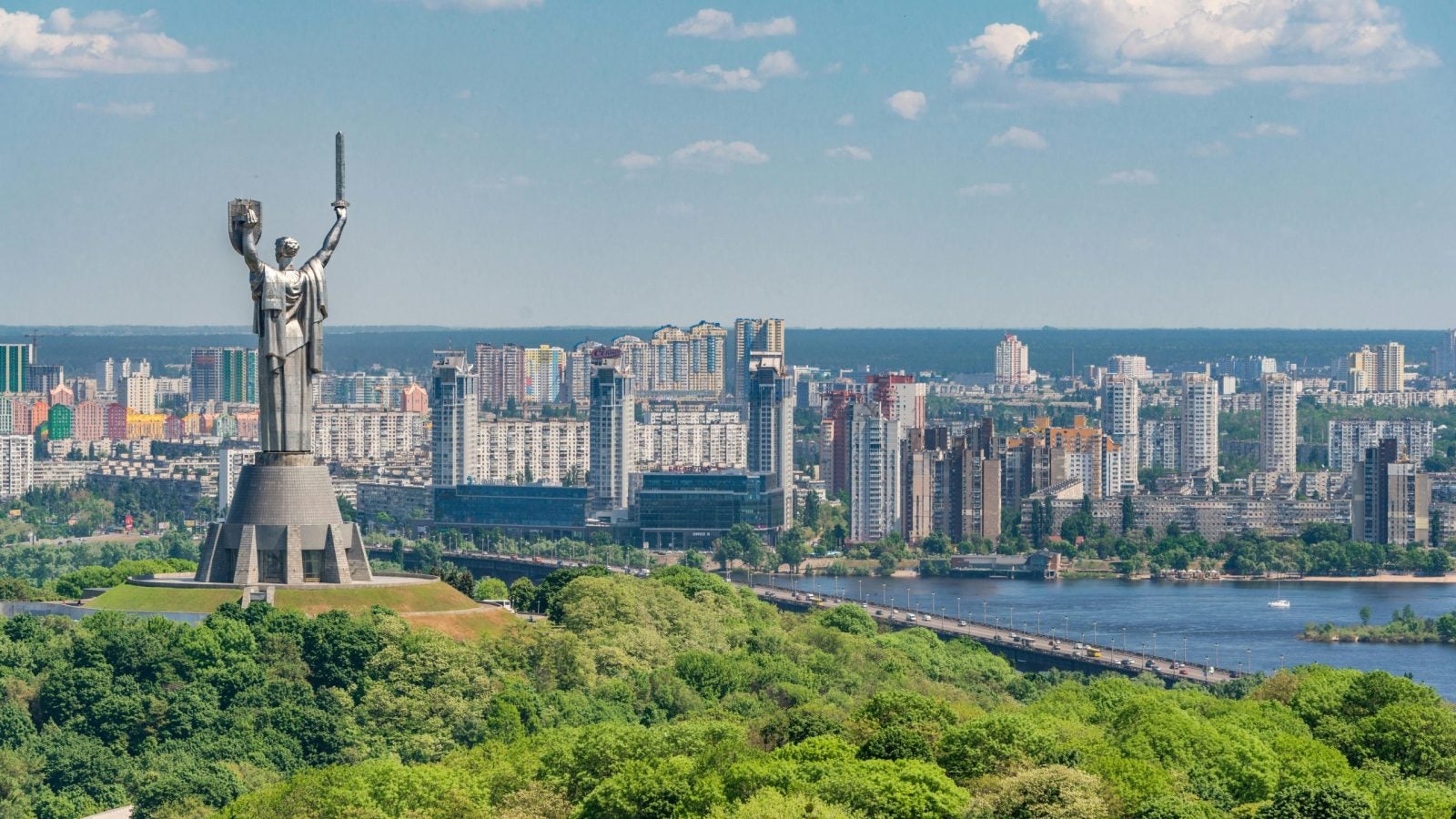 View of Kyiv, Ukraine with a tall statue overlooking the river