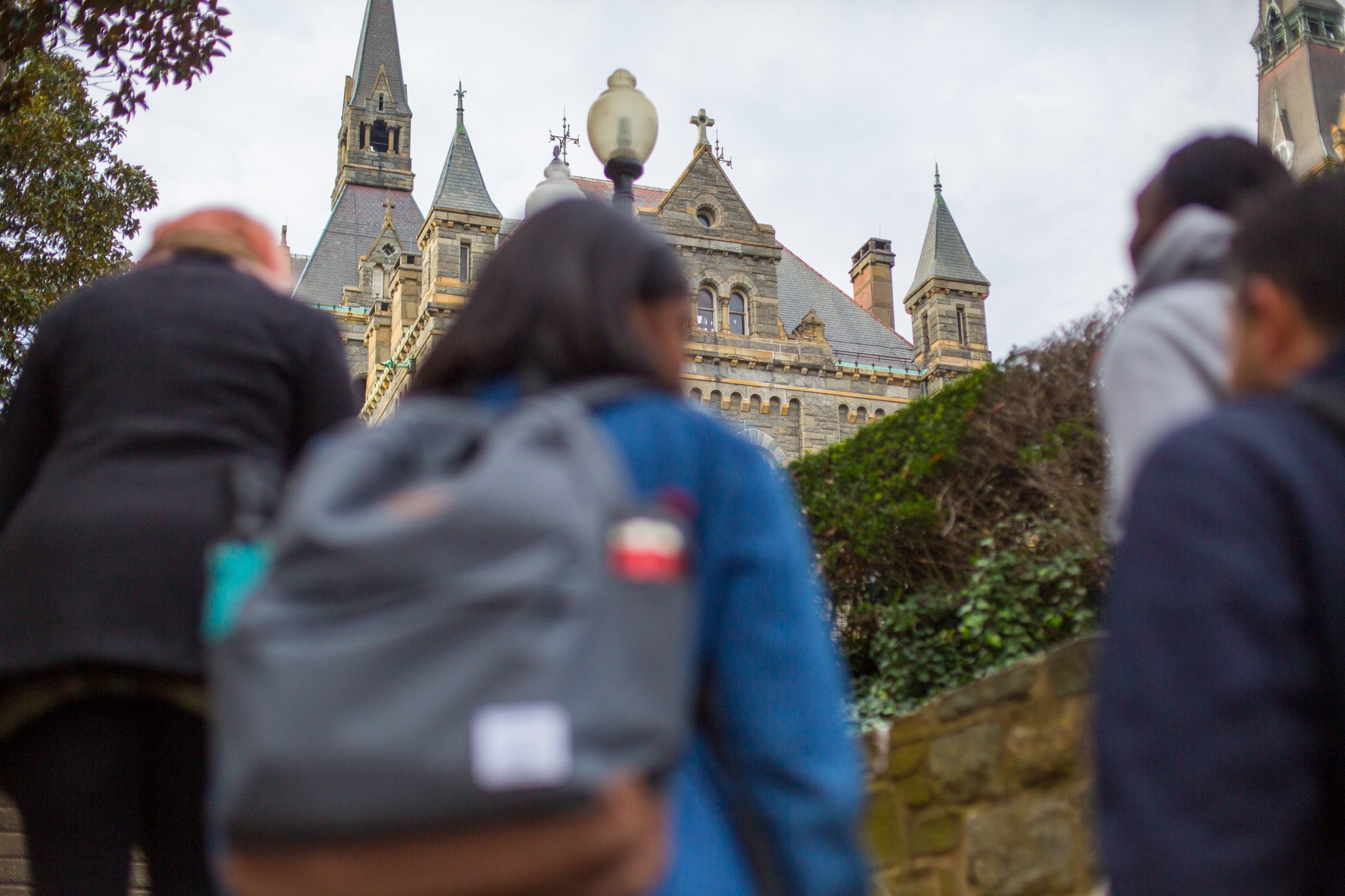 Students with backpacks walk up stairs to Georgetown.